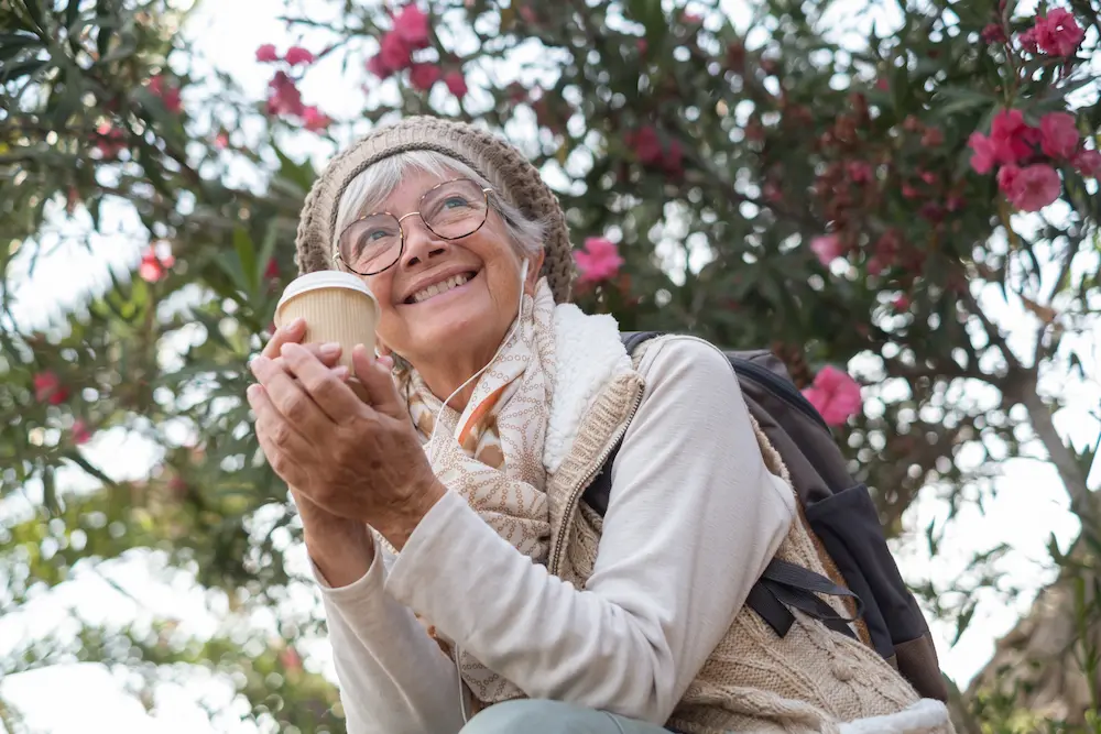 Smiling senior women enjoying coffee outdoors
